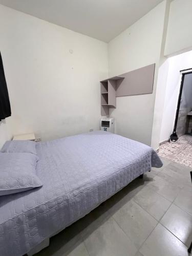 a white bedroom with a large bed in it at rinconcito en floresta in Buenos Aires