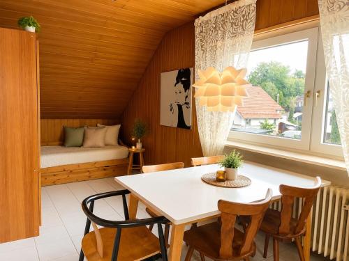 a room with a table and chairs and a bed at Odw homes - 3Room Apartment for Workers in Weinheim