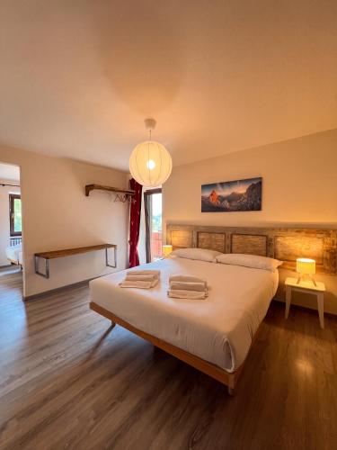 a bedroom with a large bed with two towels on it at Meublé la Ciastella in Vinadio