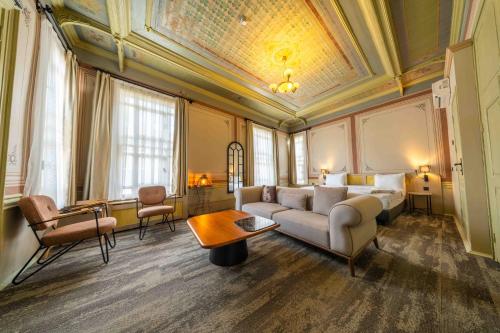 a hotel room with a bed and a couch and a table at imera hotel in Edirne