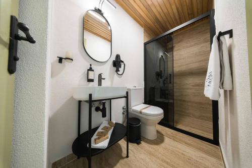 a bathroom with a sink and a toilet and a mirror at imera hotel in Edirne