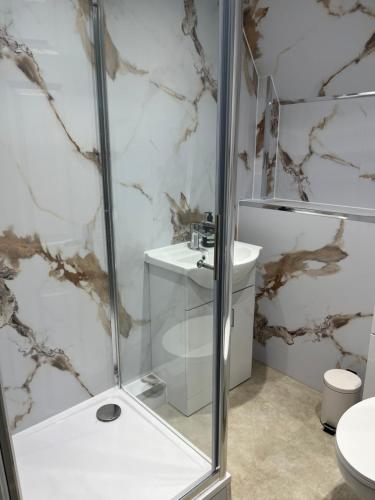 a bathroom with a shower and a sink at The Graeme Hotel in Falkirk