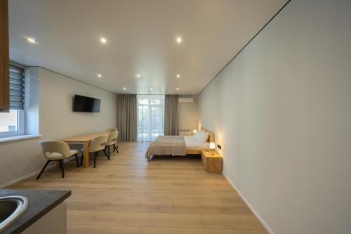 a bedroom with a bed and a table and chairs at MONTE GreeN in Polyana