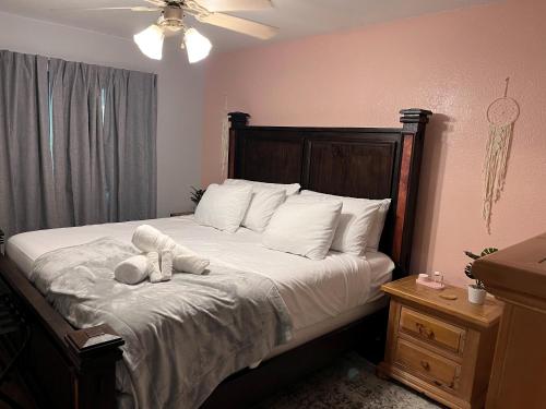 a bedroom with a bed with a teddy bear on it at Healing Haven King Bed Suite in Dallas