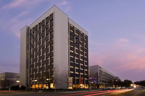 a tall building on a city street at night at The Rilano Hotel Munich, Trademark Collection by Wyndham in Munich