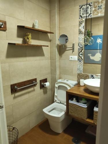 a bathroom with a toilet and a sink at Chipiona CERCA DE LA PLAYA in Chipiona