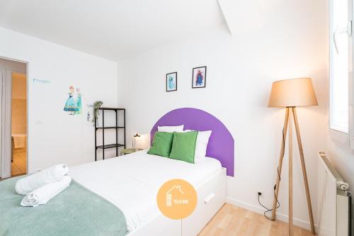 a bedroom with a white bed with a purple headboard at Duplex Le G - Reine des neiges 10 min Disney Paris in Montévrain