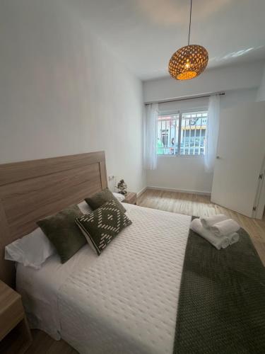 a bedroom with a large white bed with pillows at Casa Boho in Puerto de Mazarrón