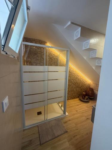 a staircase with a glass door in a room at Casa Boho in Puerto de Mazarrón