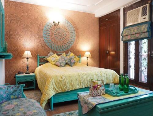 a bedroom with a bed and a couch and a table at On the House homestay in New Delhi