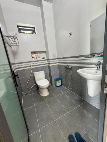 a bathroom with a toilet and a sink at Villa 1985 in Buon Ma Thuot
