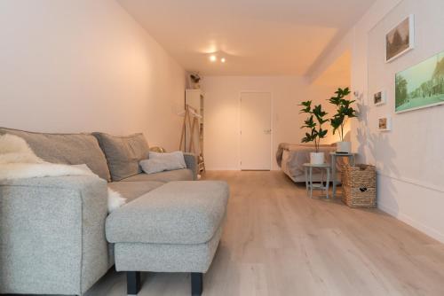 a living room with a couch and a chair at Studio Loet in Schagen