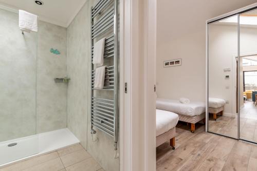 a bathroom with a shower and a tub and a sink at Tylosand, Allan Place No 8 in Earlsferry