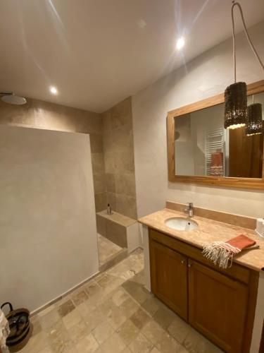 a bathroom with a sink and a mirror and a tub at Mas de grange neuve in Mollans-sur-Ouvèze