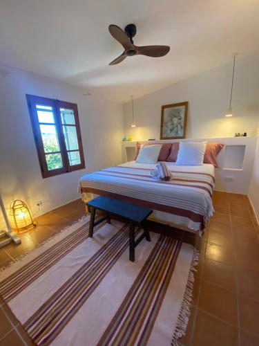 a bedroom with a large bed with a ceiling fan at Mas de grange neuve in Mollans-sur-Ouvèze