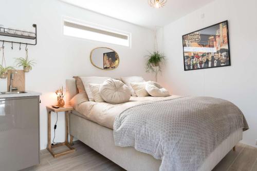a bedroom with a bed and a window and a mirror at Ben Thuis Studio Alkmaar in Alkmaar