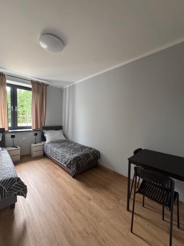 a living room with two beds and a piano at Horiza Białe Błota in Białe Błota