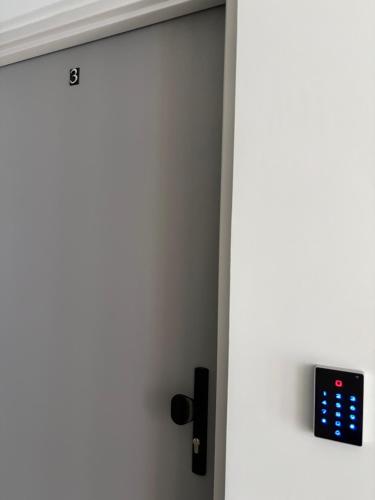 an open door with an apple watch on it at Horiza Białe Błota in Białe Błota