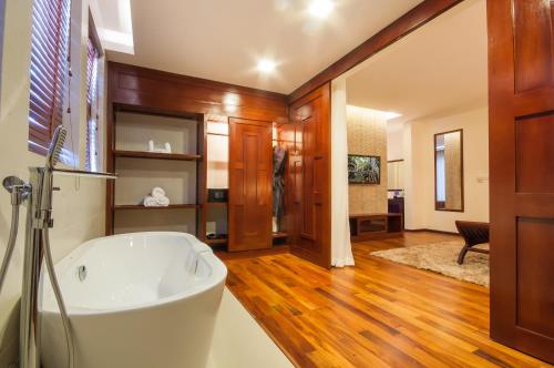 a bathroom with a white tub in a room at Lotus Blanc Resort in Siem Reap