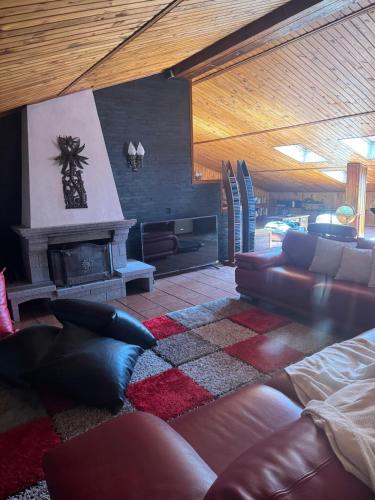 a living room with a couch and a fireplace at Casa do Alto in Recarei