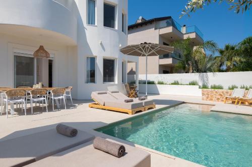 a villa with a swimming pool and a patio at Villa Rhodea in Ialysos