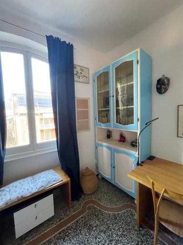 a room with a desk and a blue cabinet at Baia Serena in Sestri Levante