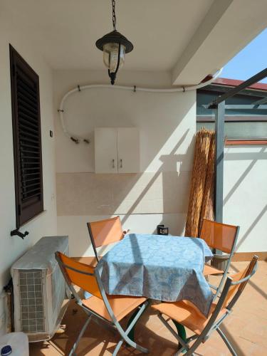 a patio with a table and chairs in a room at Villa Cristina in Triscina