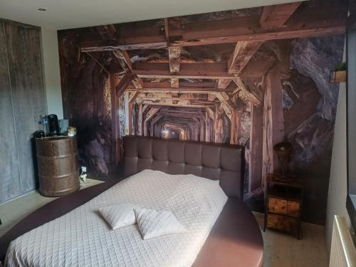 a bed with two pillows on it in a room at Chambre d'hôtes "Sur la route des Terrils" in Vendin-le-Vieil