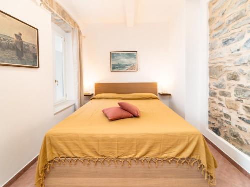 a bedroom with a bed with two pillows on it at Borgo Pasqui in Diano Marina