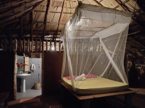 a canopy bed in a bathroom with a sink at Nature Kingdom Sri Lanka in Hambegamuwa