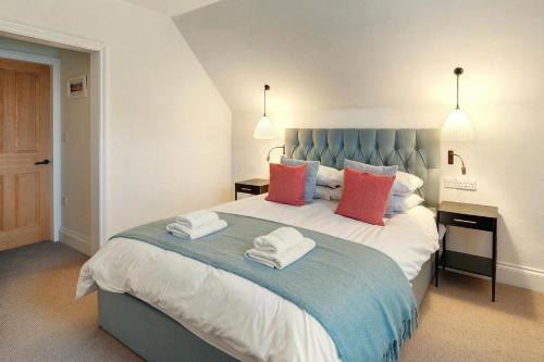 a bedroom with a large bed with towels on it at 4 Bed in Windermere oc-lr026 in Windermere