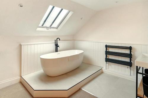 a bathroom with a tub in the middle of a room at 4 Bed in Windermere oc-lr026 in Windermere