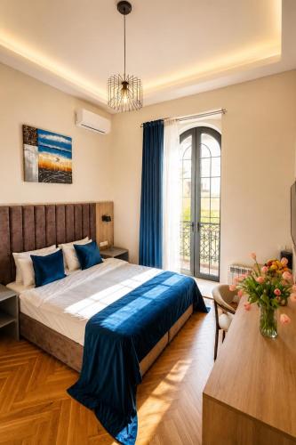 a bedroom with a bed and a large window at BS Studios in Baku