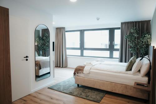 a bedroom with a large mirror and a bed at The Haus KAI Nuremberg in Nuremberg