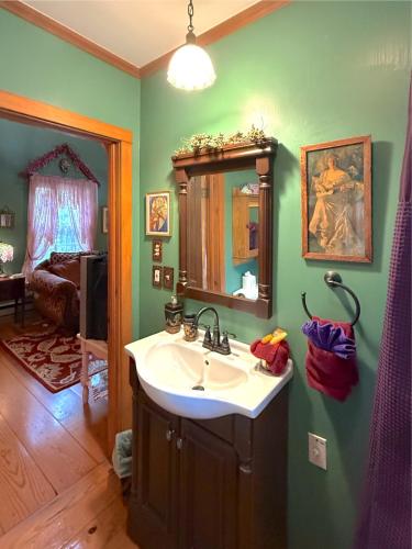a bathroom with a sink and a mirror at Blue Crystal Hideaway BnB in Eureka Springs
