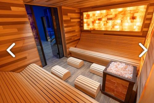 an empty sauna with two benches and a table at Apartmani Pužić in Kopaonik