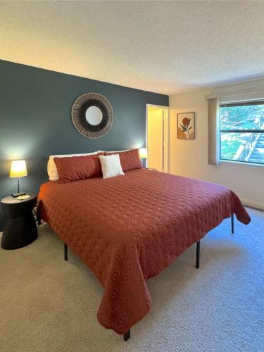 a bedroom with a large bed with a red comforter at The Treehouse on Table Rock in Eureka Springs