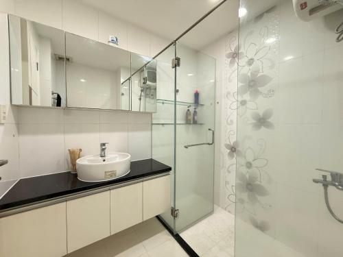a bathroom with a sink and a glass shower at StayX Sky Garden in Ba Ria
