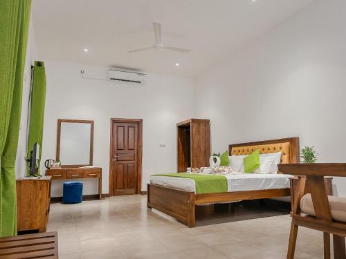 a bedroom with a bed and a mirror at Grandpa's villa Jaffna in Jaffna