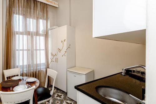 a kitchen with a sink and a table in a room at Felicity Palace Sirkeci in Istanbul