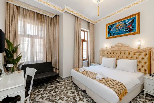 a bedroom with a king sized bed and a desk at Felicity Palace Sirkeci in Istanbul