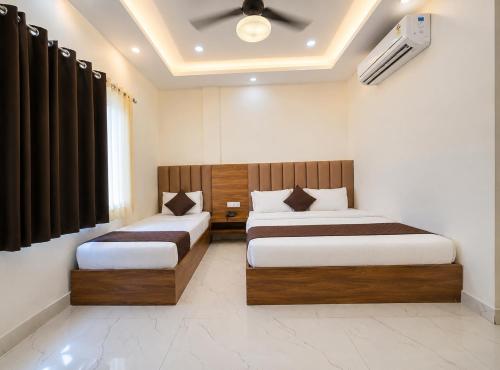 a bedroom with two beds and a ceiling at Velora hotele in Amritsar