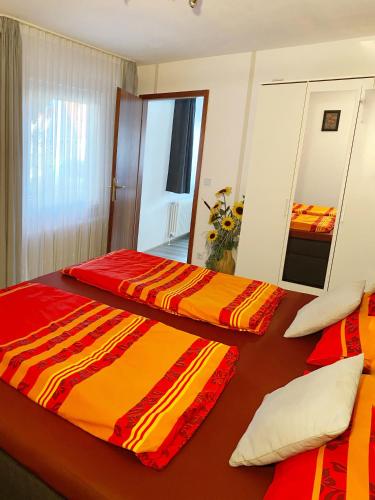 two beds in a hotel room with a mirror at Charlottenhöhe Apartment in Rottweil
