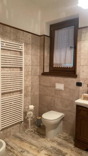 a bathroom with a toilet and a sink at Villa Manca in San Severino Lucano