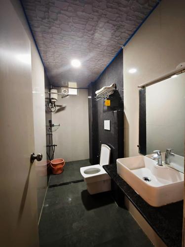 a bathroom with a sink and a toilet at The Mangrove Cove "200Mtrs from Beach" in Shādipur