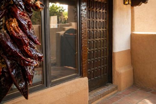 a window of a store with a reflection in it at Las Brisas de Santa fe in Santa Fe
