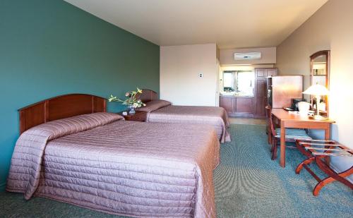 Ένα ή περισσότερα κρεβάτια σε δωμάτιο στο Hotel-Motel Drummond