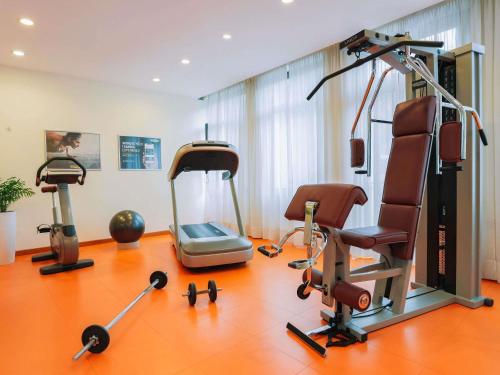 a gym with three exercise bikes and a treadmill at Mercure Roma Piazza Bologna in Rome