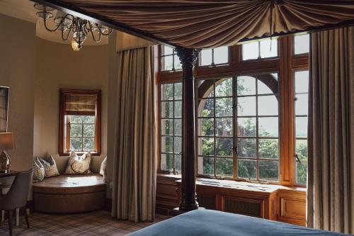 a bedroom with a bed and a large window at Murrayshall Country Estate in Perth