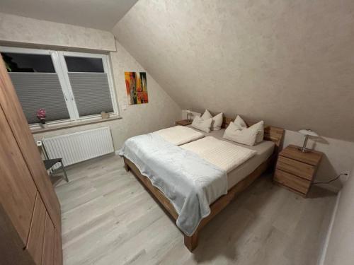 a bedroom with a bed and a window at Apartment Grieshop in Dinklage